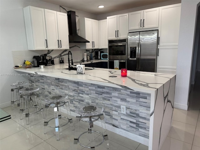 10060 NW 86th Ter, Doral, FL 33178 - kitchen with appliances with stainless steel finishes, wall chimney range hood, baseboards, a peninsula, and recessed lighting