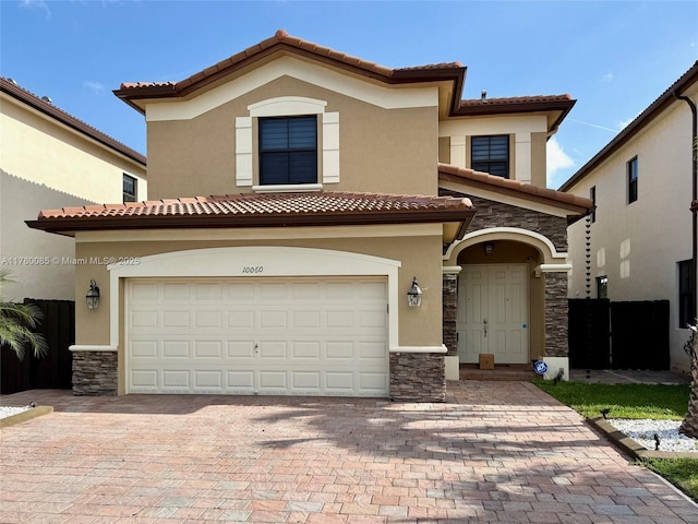 10060 NW 86th Ter, Doral, FL 33178 - mediterranean / spanish house with a tiled roof, stucco siding, stone siding, and decorative driveway