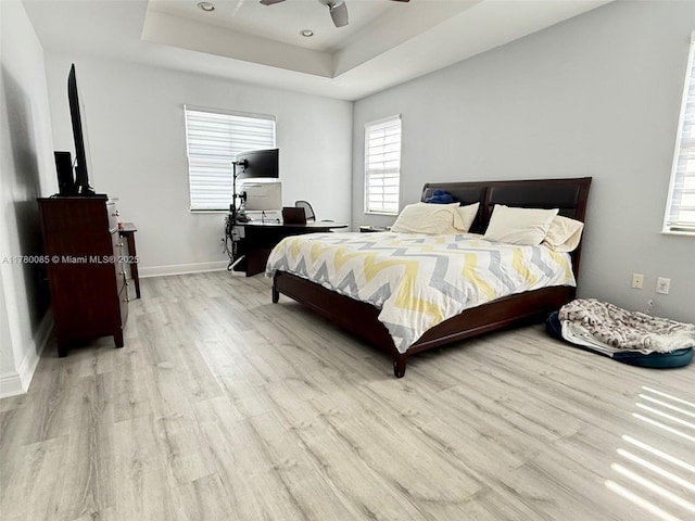 10060 NW 86th Ter, Doral, FL 33178 - bedroom featuring light wood finished floors, a raised ceiling, baseboards, and a ceiling fan