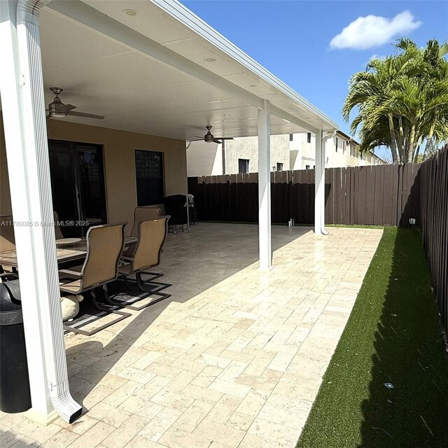10060 NW 86th Ter, Doral, FL 33178 - fenced backyard featuring a ceiling fan and a patio