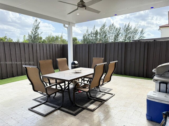 10060 NW 86th Ter, Doral, FL 33178 - fenced backyard with a ceiling fan, outdoor dining area, and a patio