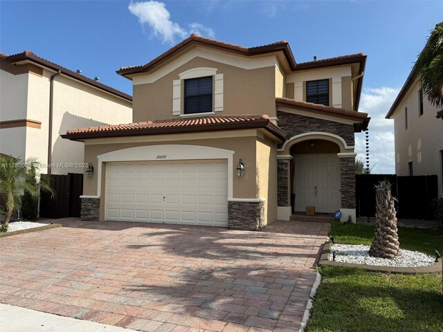 10060 NW 86th Ter, Doral, FL 33178 - view of front of property with stone siding, stucco siding, driveway, and a garage