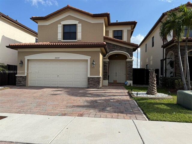 10060 NW 86th Ter, Doral, FL 33178 - view of front facade with stone siding, stucco siding, a tile roof, decorative driveway, and an attached garage