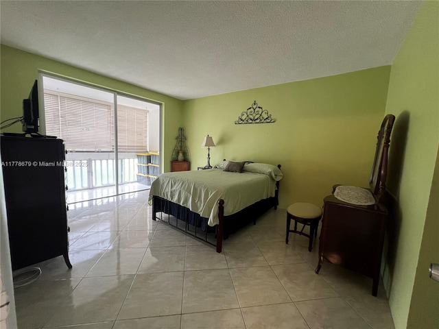 18555 NE 14th Ave Unit 516, Miami, FL 33179 - bedroom with light tile patterned floors and a textured ceiling