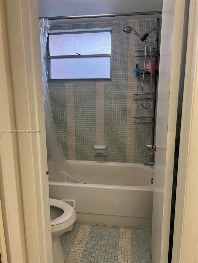18555 NE 14th Ave Unit 516, Miami, FL 33179 - bathroom with toilet, shower / bath combo with shower curtain, and tile patterned flooring