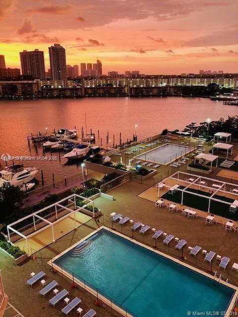 18061 Biscayne Blvd Unit 802, Aventura, FL 33160 - aerial view at dusk of a view of skyline, a water view, and view of pool area