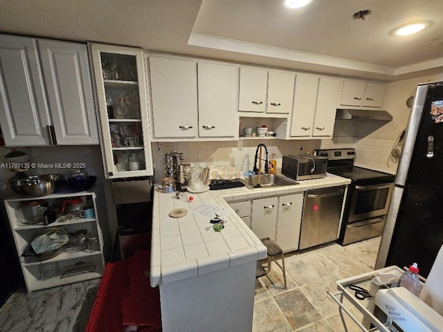 18061 Biscayne Blvd Unit 802, Aventura, FL 33160 - kitchen with appliances with stainless steel finishes, tile countertops, a sink, a tray ceiling, and white cabinetry