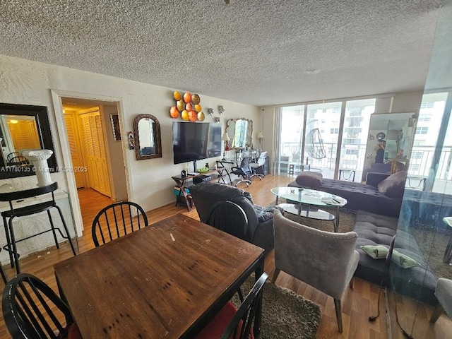 18061 Biscayne Blvd Unit 802, Aventura, FL 33160 - dining room featuring wood finished floors and a textured ceiling