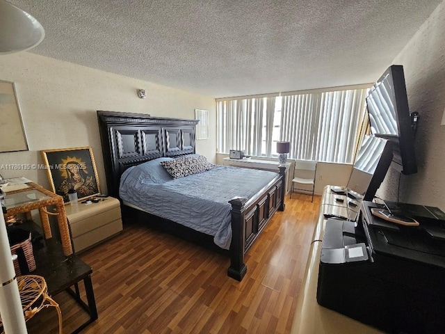 18061 Biscayne Blvd Unit 802, Aventura, FL 33160 - bedroom featuring a textured ceiling and light wood-style floors