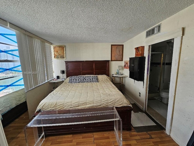 18061 Biscayne Blvd Unit 802, Aventura, FL 33160 - bedroom featuring a textured ceiling, wood finished floors, and multiple windows