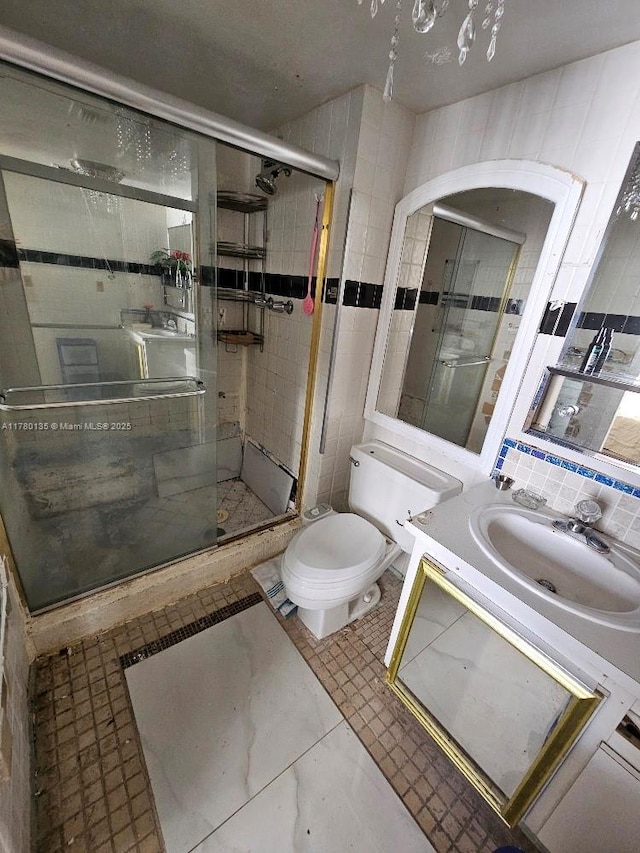 18061 Biscayne Blvd Unit 802, Aventura, FL 33160 - bathroom featuring toilet, a shower stall, vanity, and decorative backsplash