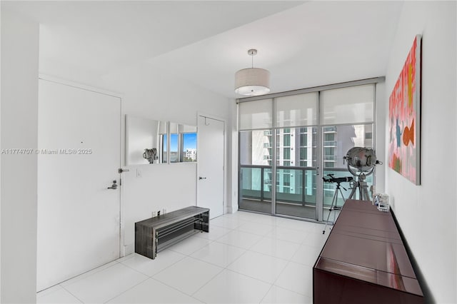 interior space featuring tile patterned flooring and floor to ceiling windows
