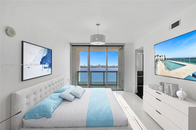 bedroom featuring visible vents, access to outside, and floor to ceiling windows