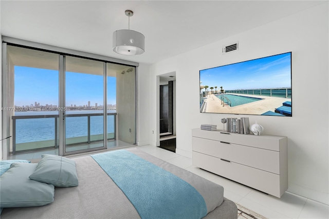 bedroom featuring visible vents, access to outside, light tile patterned flooring, and expansive windows