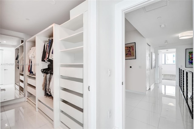 walk in closet with light tile patterned floors and visible vents