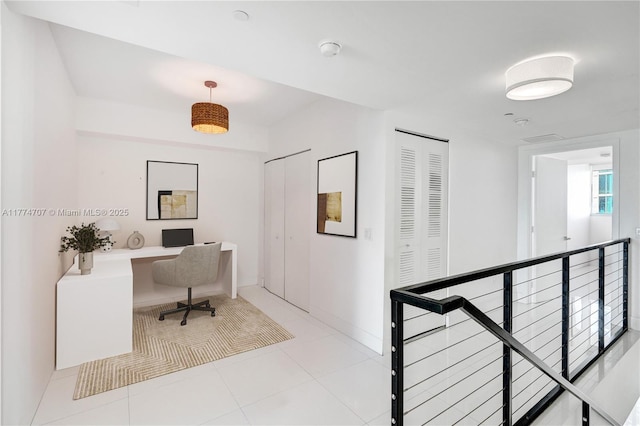 office area featuring light tile patterned flooring and baseboards