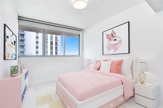 bedroom featuring light tile patterned flooring and baseboards