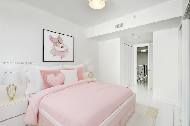 bedroom featuring light tile patterned floors and visible vents