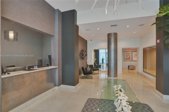 welcome area with decorative columns and visible vents