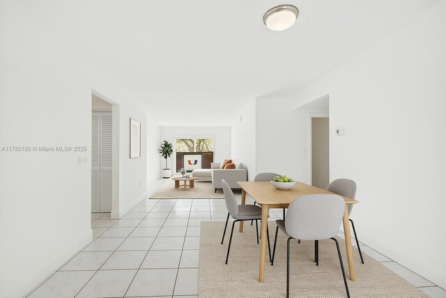 dining space with light tile patterned floors and baseboards