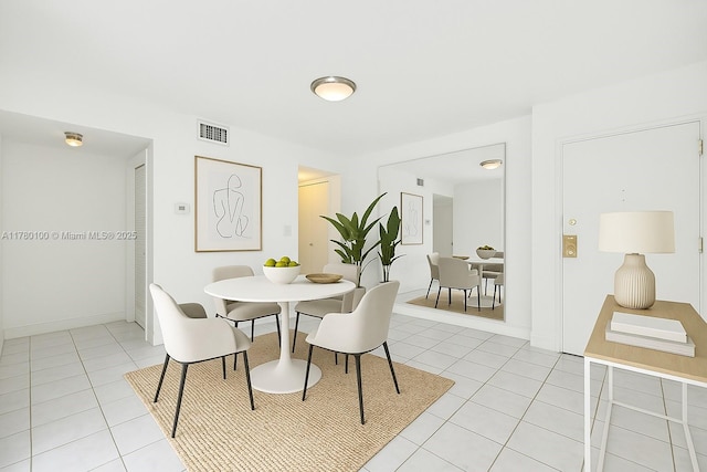 dining room with light tile patterned flooring, baseboards, and visible vents