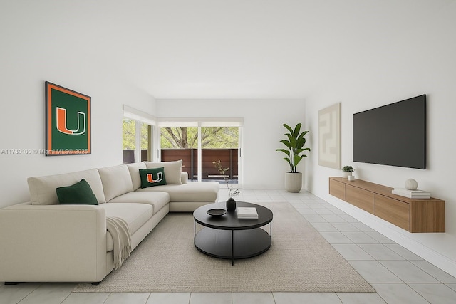 living room with light tile patterned floors and baseboards