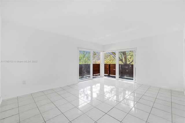 spare room featuring light tile patterned floors