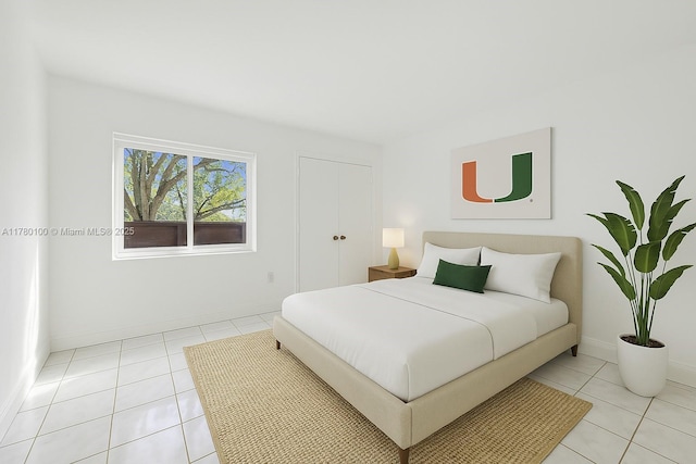 bedroom with light tile patterned floors and baseboards