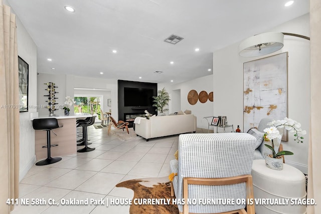 411 NE 58th Ct, Oakland Park, FL 33334 - living area featuring light tile patterned floors, visible vents, baseboards, and recessed lighting