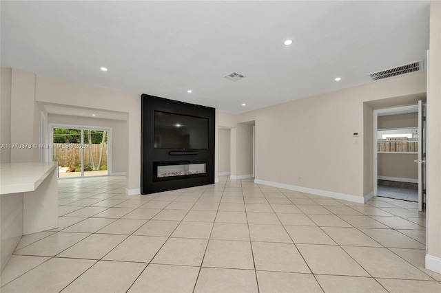 411 NE 58th Ct, Oakland Park, FL 33334 - unfurnished living room with light tile patterned floors, visible vents, baseboards, and recessed lighting