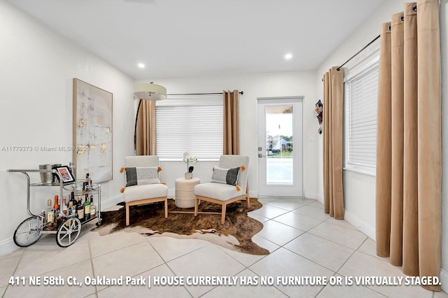 411 NE 58th Ct, Oakland Park, FL 33334 - living area featuring tile patterned floors, baseboards, and recessed lighting