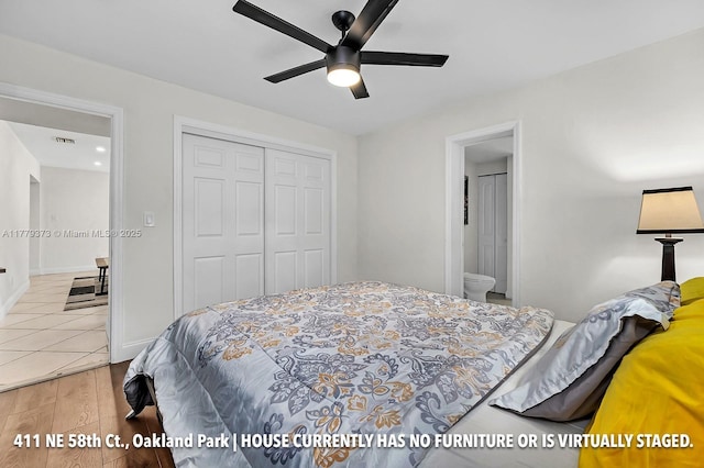 411 NE 58th Ct, Oakland Park, FL 33334 - bedroom featuring wood finished floors, a ceiling fan, a closet, ensuite bathroom, and visible vents