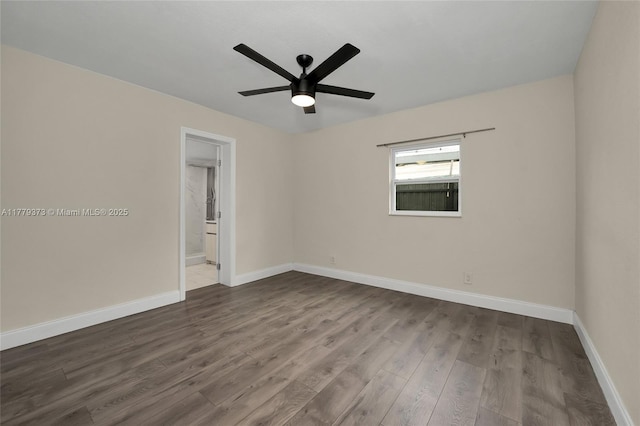 411 NE 58th Ct, Oakland Park, FL 33334 - spare room with dark wood-type flooring, baseboards, and a ceiling fan