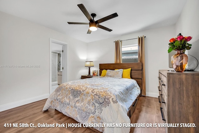 411 NE 58th Ct, Oakland Park, FL 33334 - bedroom with baseboards, ensuite bath, and wood finished floors