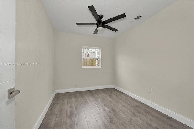 411 NE 58th Ct, Oakland Park, FL 33334 - empty room featuring baseboards, visible vents, wood finished floors, and a ceiling fan