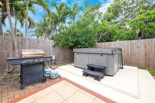 411 NE 58th Ct, Oakland Park, FL 33334 - view of patio / terrace with a grill, a hot tub, and a fenced backyard