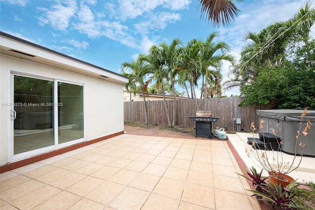 411 NE 58th Ct, Oakland Park, FL 33334 - view of patio / terrace with a hot tub and fence