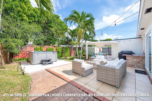 411 NE 58th Ct, Oakland Park, FL 33334 - view of patio / terrace with a hot tub, grilling area, a fenced backyard, and visible vents