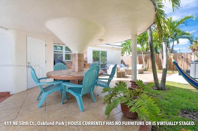 411 NE 58th Ct, Oakland Park, FL 33334 - view of patio / terrace featuring an outdoor hangout area, outdoor dining area, and fence
