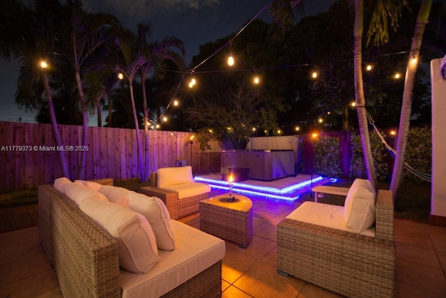 411 NE 58th Ct, Oakland Park, FL 33334 - patio at twilight featuring an outdoor hangout area and a fenced backyard
