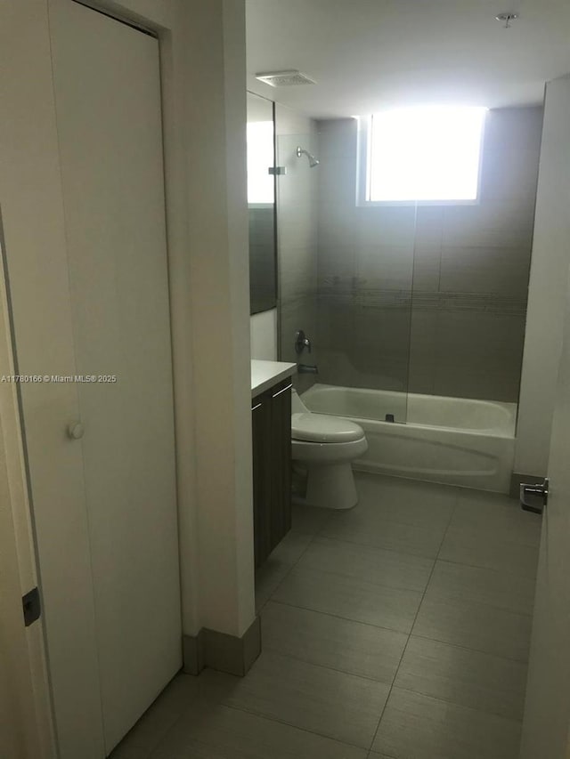 full bathroom featuring bathing tub / shower combination, tile patterned floors, vanity, and toilet
