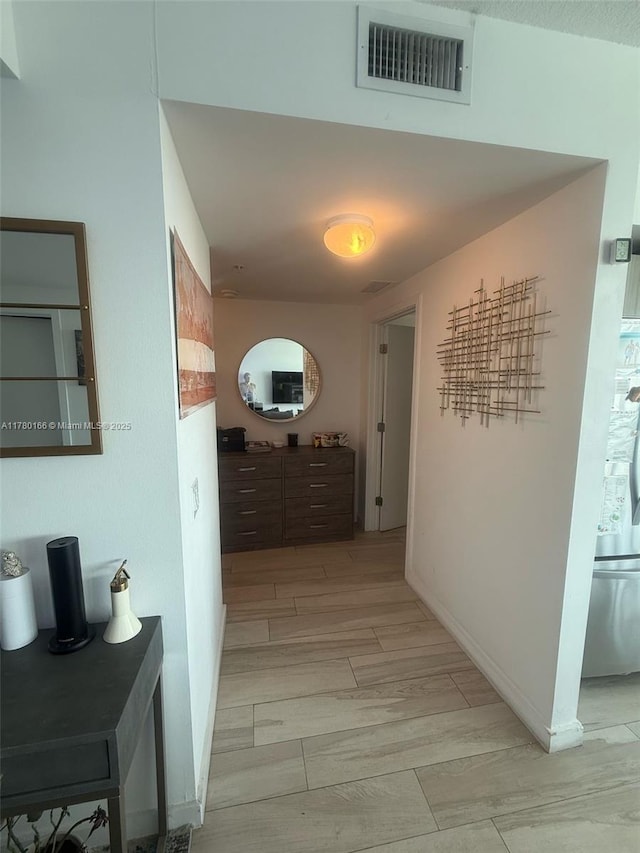 corridor with visible vents and baseboards