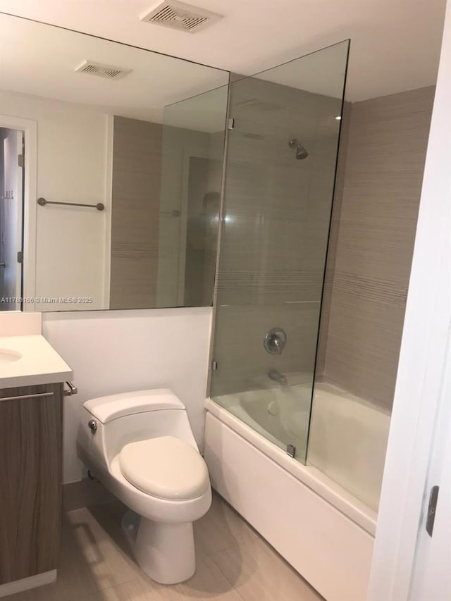 full bath with toilet, shower / bath combination with glass door, vanity, and visible vents