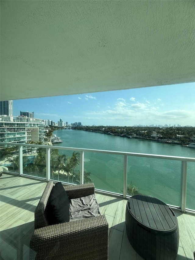 balcony featuring a water view and a view of city