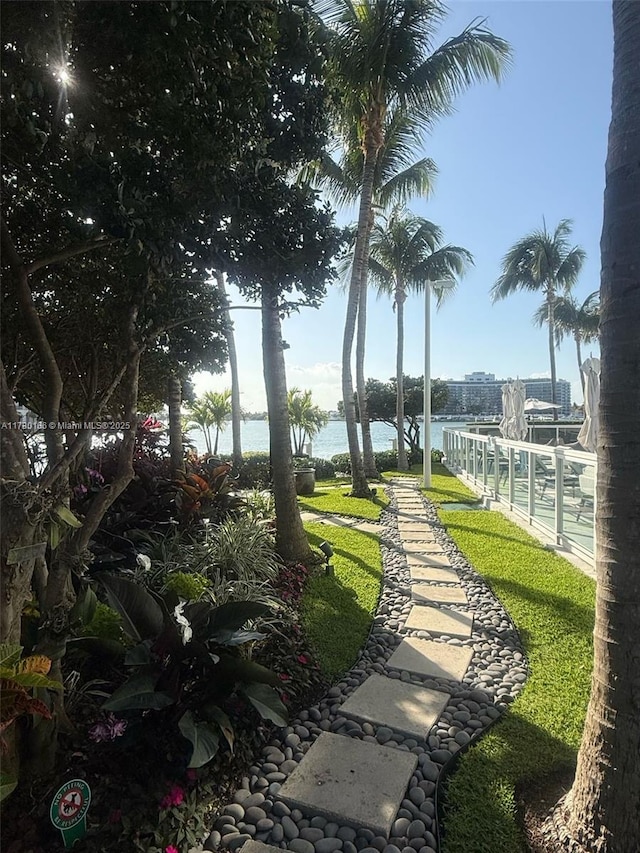 surrounding community featuring a water view and shuffleboard