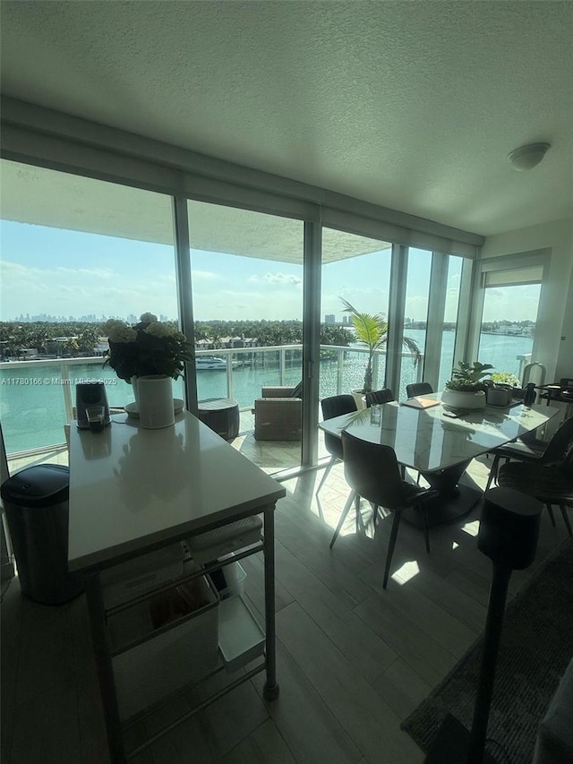 sunroom / solarium with plenty of natural light and a water view