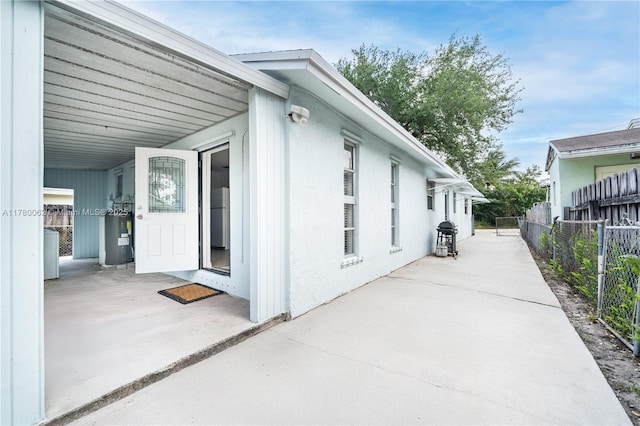 5715 Garfield St, Hollywood, FL 33021 - view of side of property with a patio, fence, and electric water heater