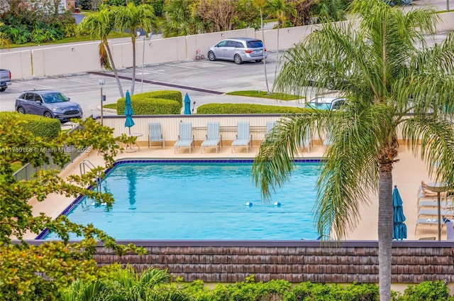 view of swimming pool featuring fence and a fenced in pool