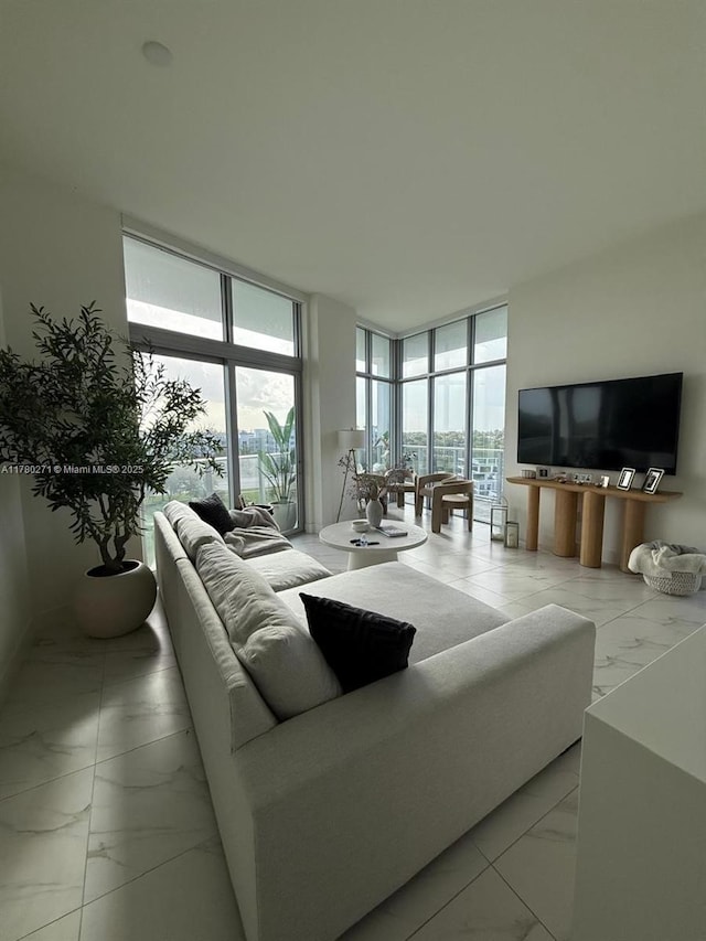 2000 Metropica Way Unit 603, Sunrise, FL 33323 - living area featuring marble look tiles, a wall of windows, and healthy amount of natural light