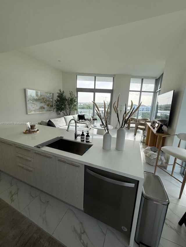 2000 Metropica Way Unit 603, Sunrise, FL 33323 - kitchen featuring dishwasher, light countertops, healthy amount of natural light, open floor plan, and floor to ceiling windows
